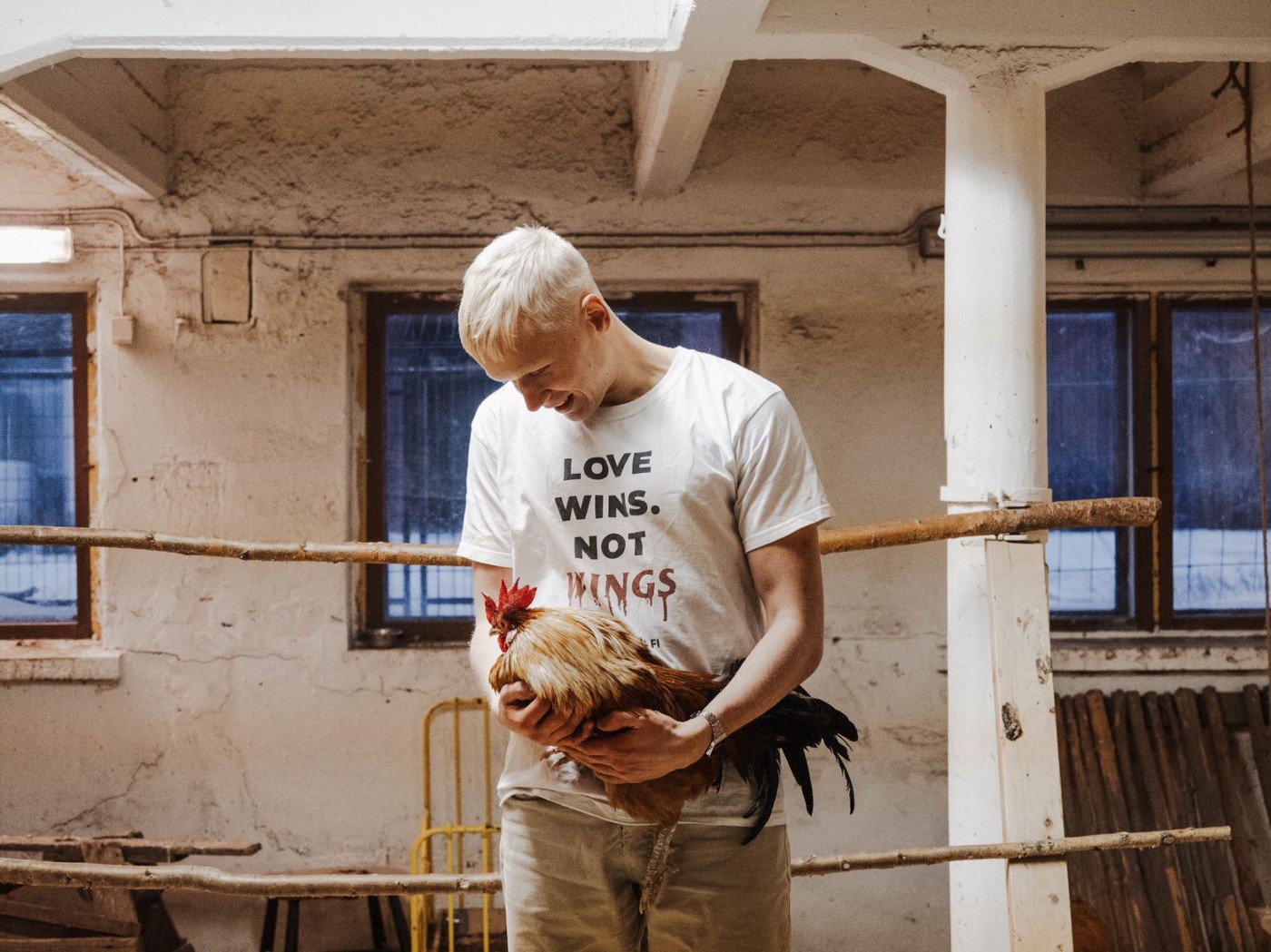 Benjamin Pitkänen, co-founder of Viral Vegans, holding a rooster. 