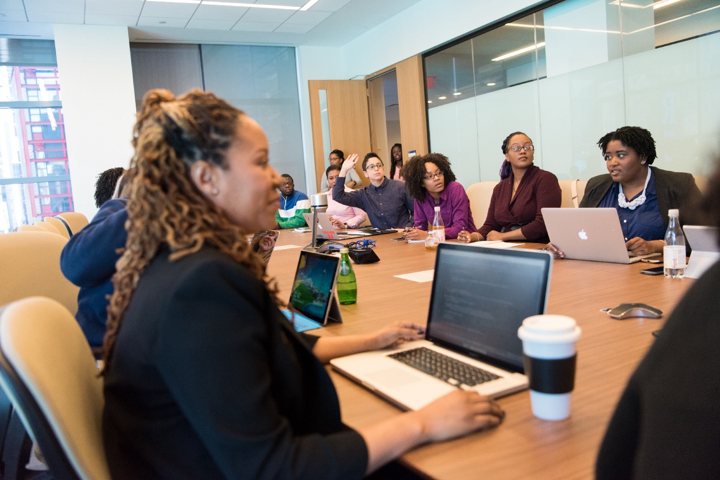 People sitting at a table talking about DEI. 