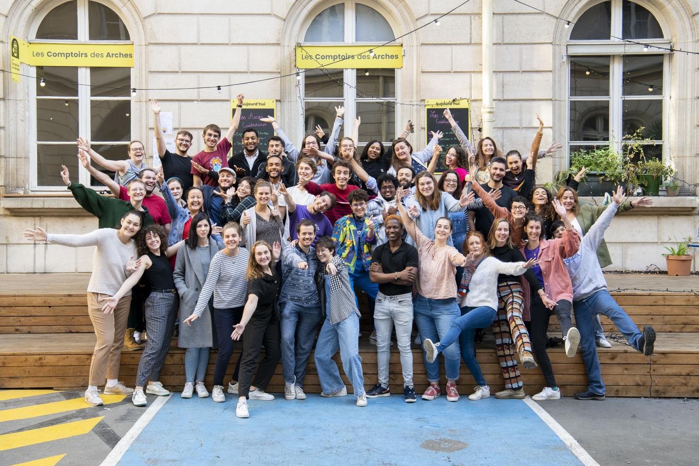A group of young people pose in celebration with their arms and legs raised