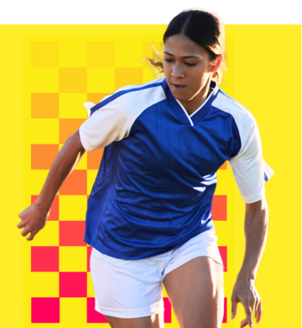 A photo of a young woman with brown hair wearing a blue and white jersey. She appears to be running, looking towards the ground as if chasing a football. She is superimposed over a yellow background with a magenta checkerboard graphic.